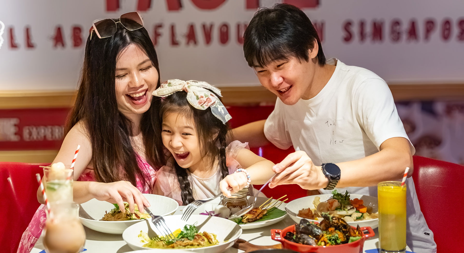 A happy family enjoying a meal at Ibis Singapore on Bencoolen restaurant.